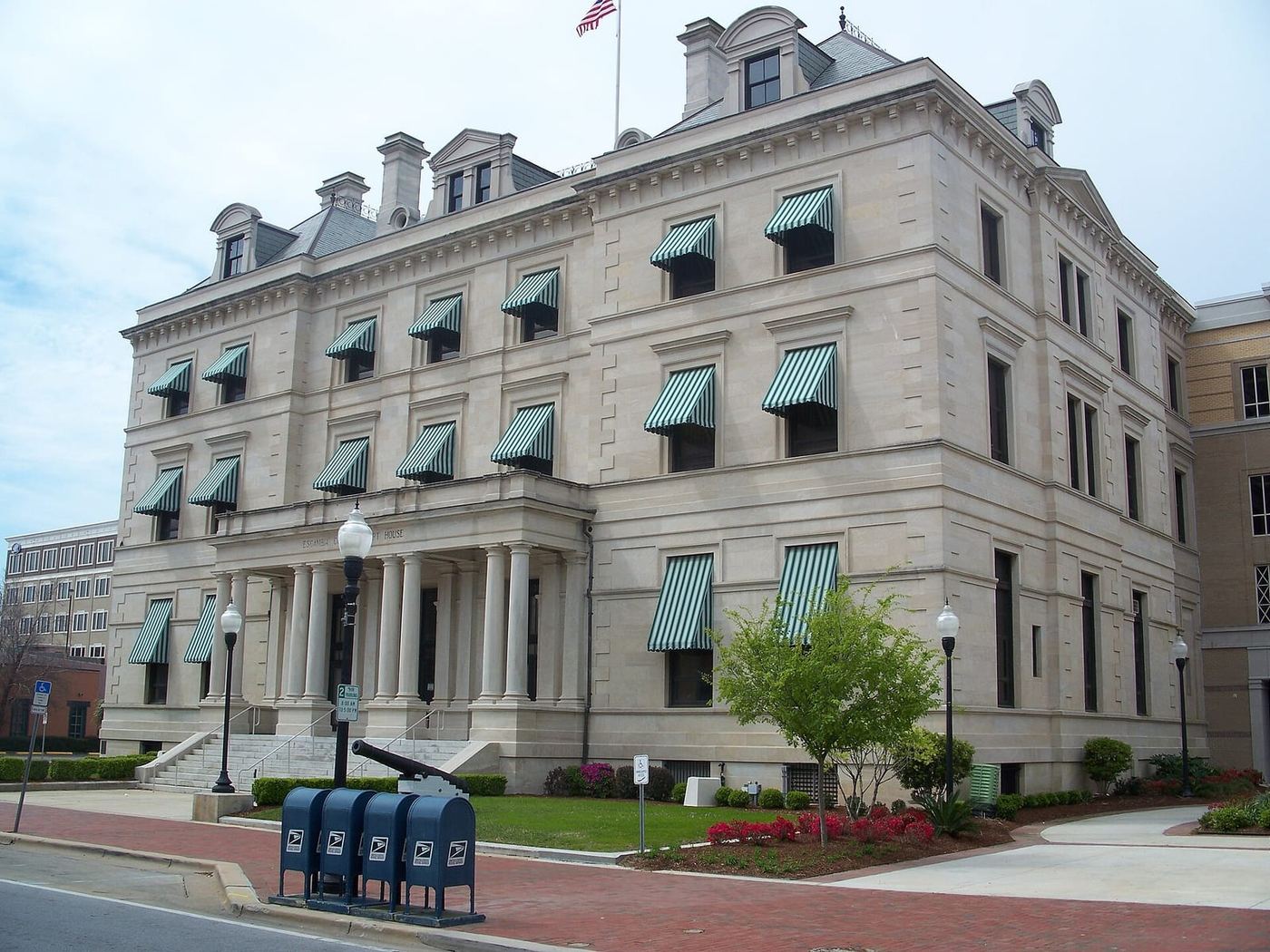 The Escambia County Court House, a light stone building with green striped awnings, in downtown Pensacola