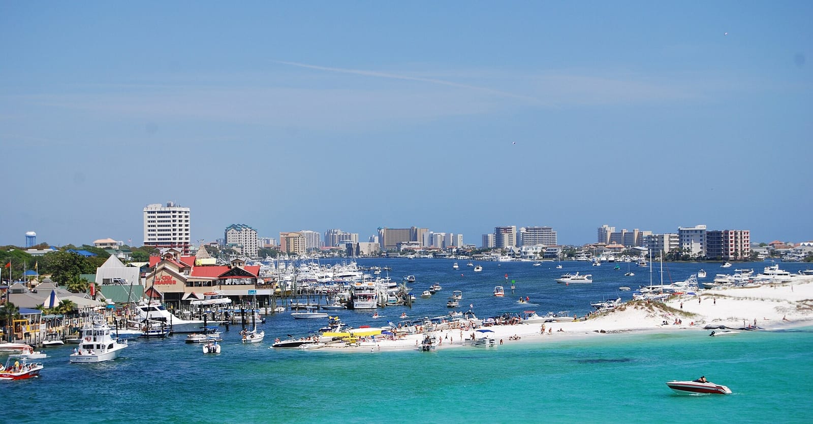 Boats and the HarborWalk along Destin Harbor with the Gulf beyond