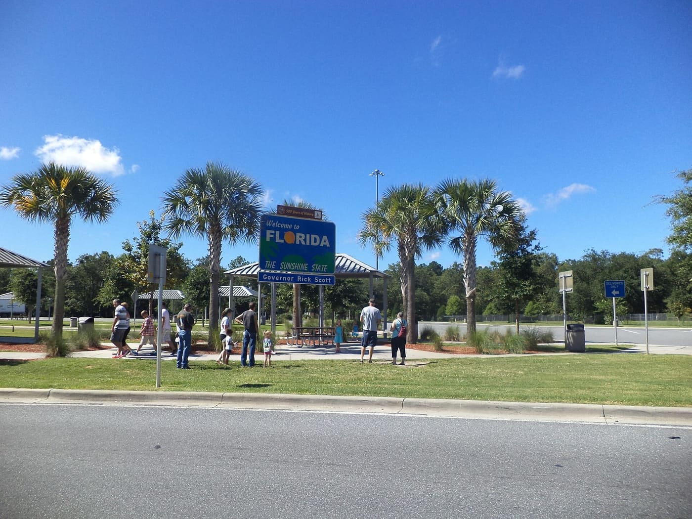 Welcome to Florida sign surrounded by palm trees at the state line