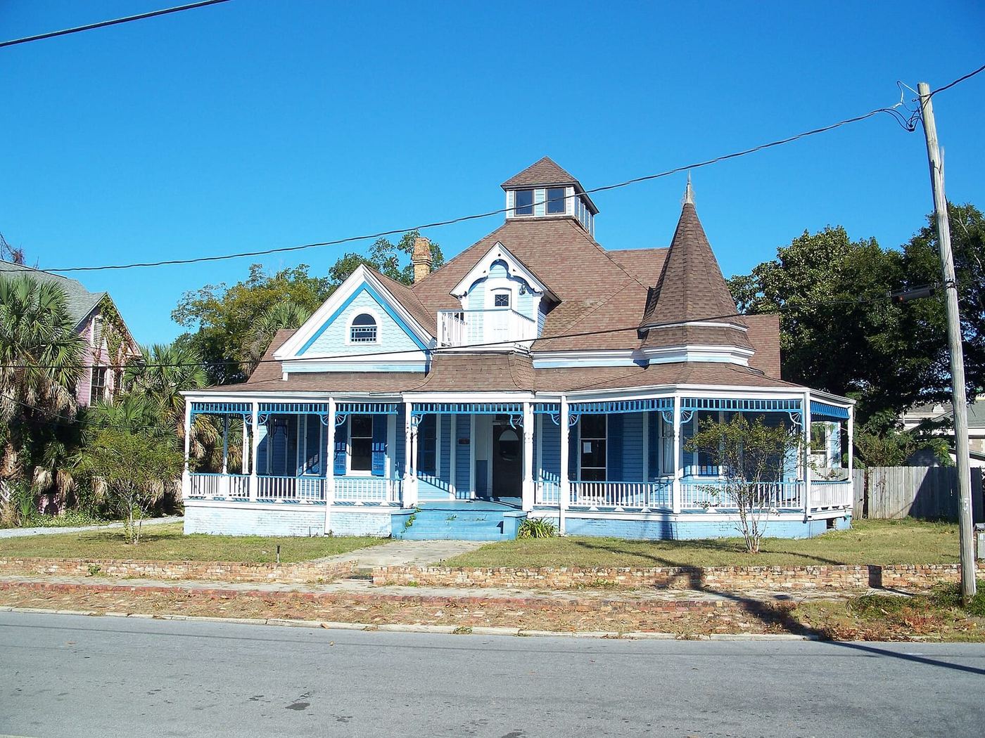 Blue Victorian house with a wraparound porch and a turret in Pensacola's North Hill neighborhood